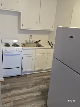 a close view of sink a microwave and cabinets