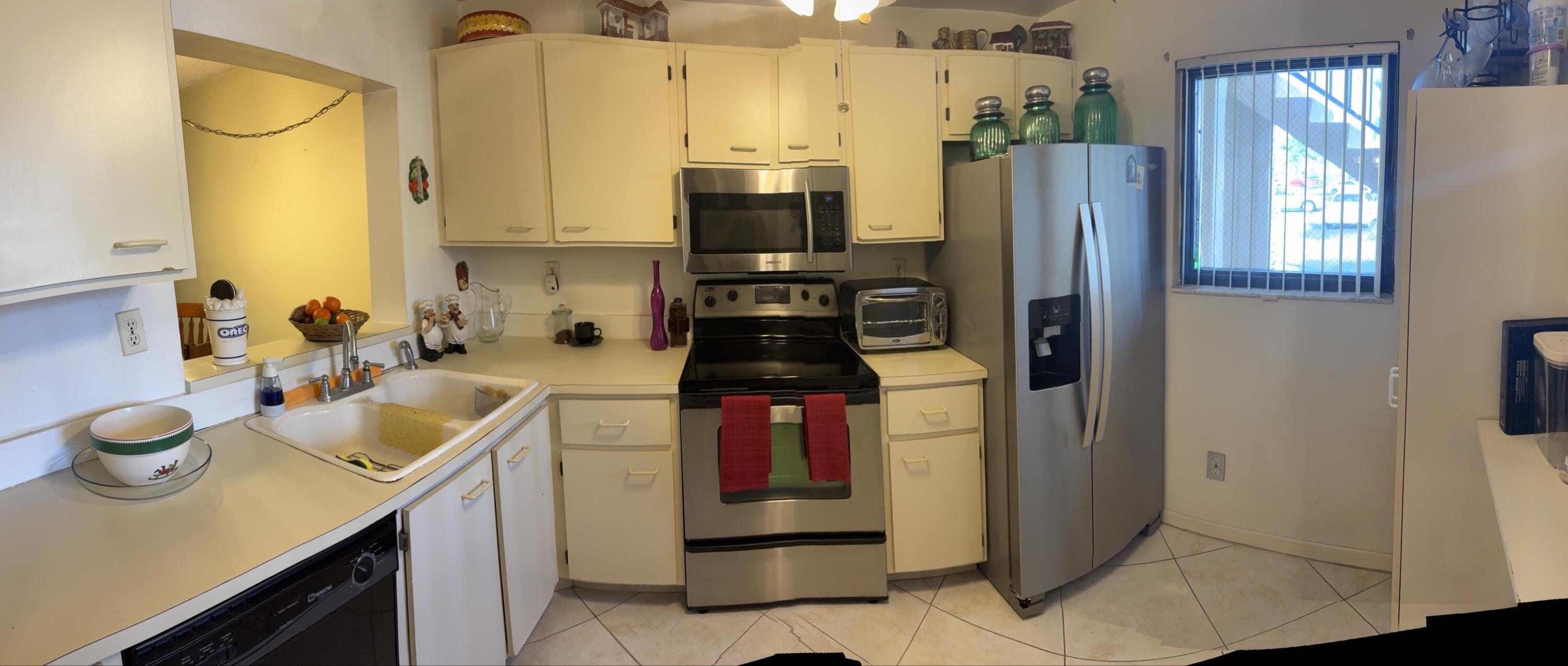 9503 Boca Cove Circle, Unit 602 Boca Raton, FL 33428 - Photo 12 of 24 a kitchen with refrigerator and window
