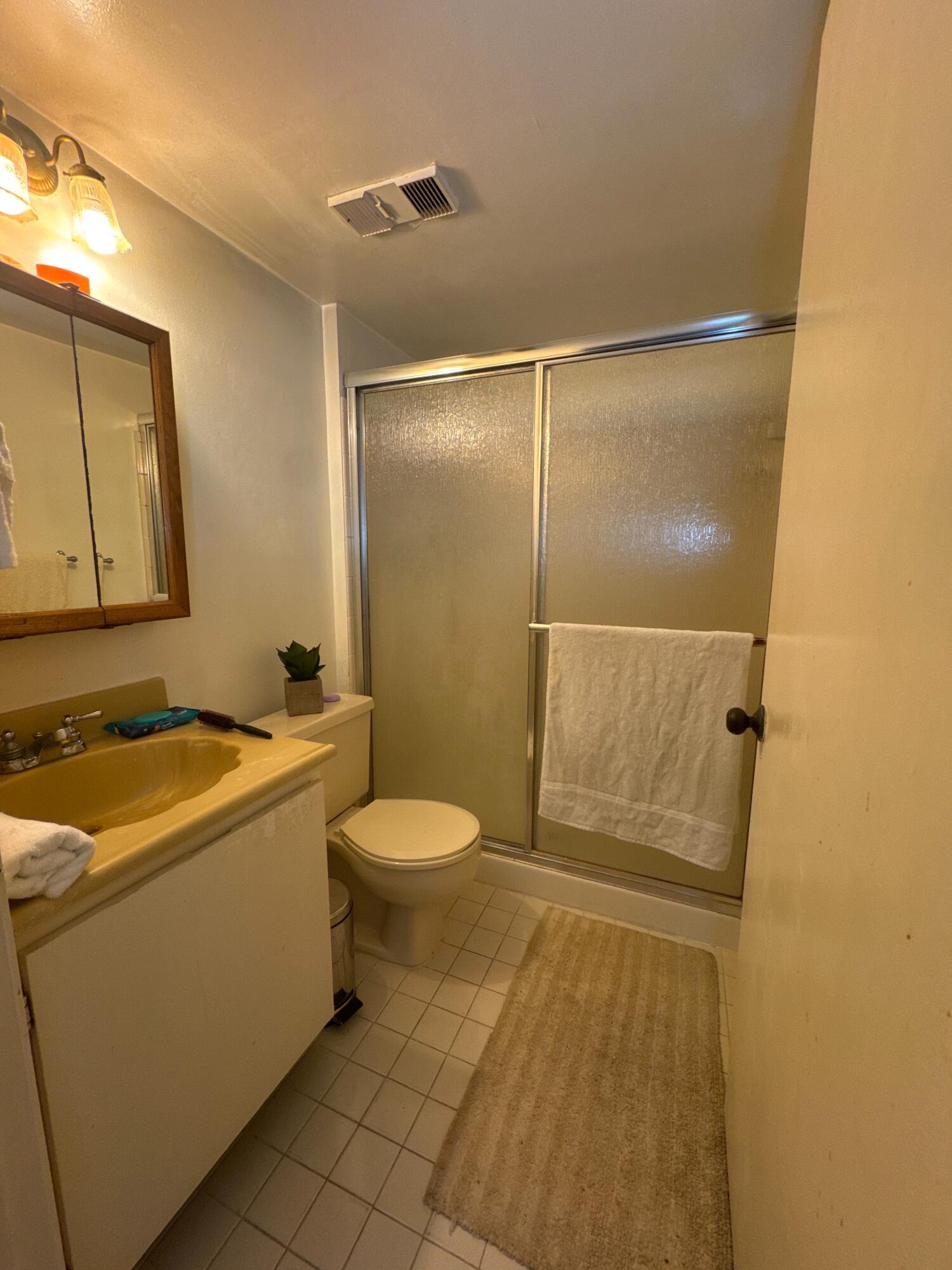 9503 Boca Cove Circle, Unit 602 Boca Raton, FL 33428 - Photo 14 of 24 a bathroom with a sink a toilet and shower