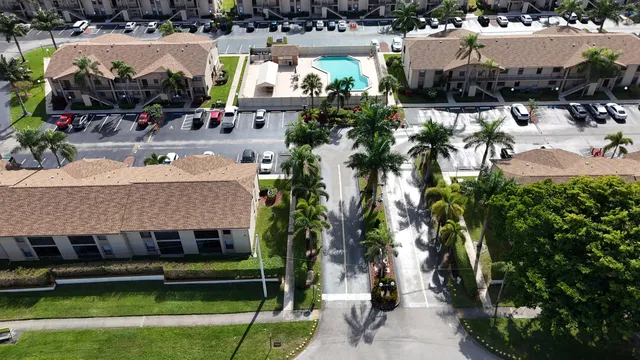 a aerial view of a house with a yard table and chairs