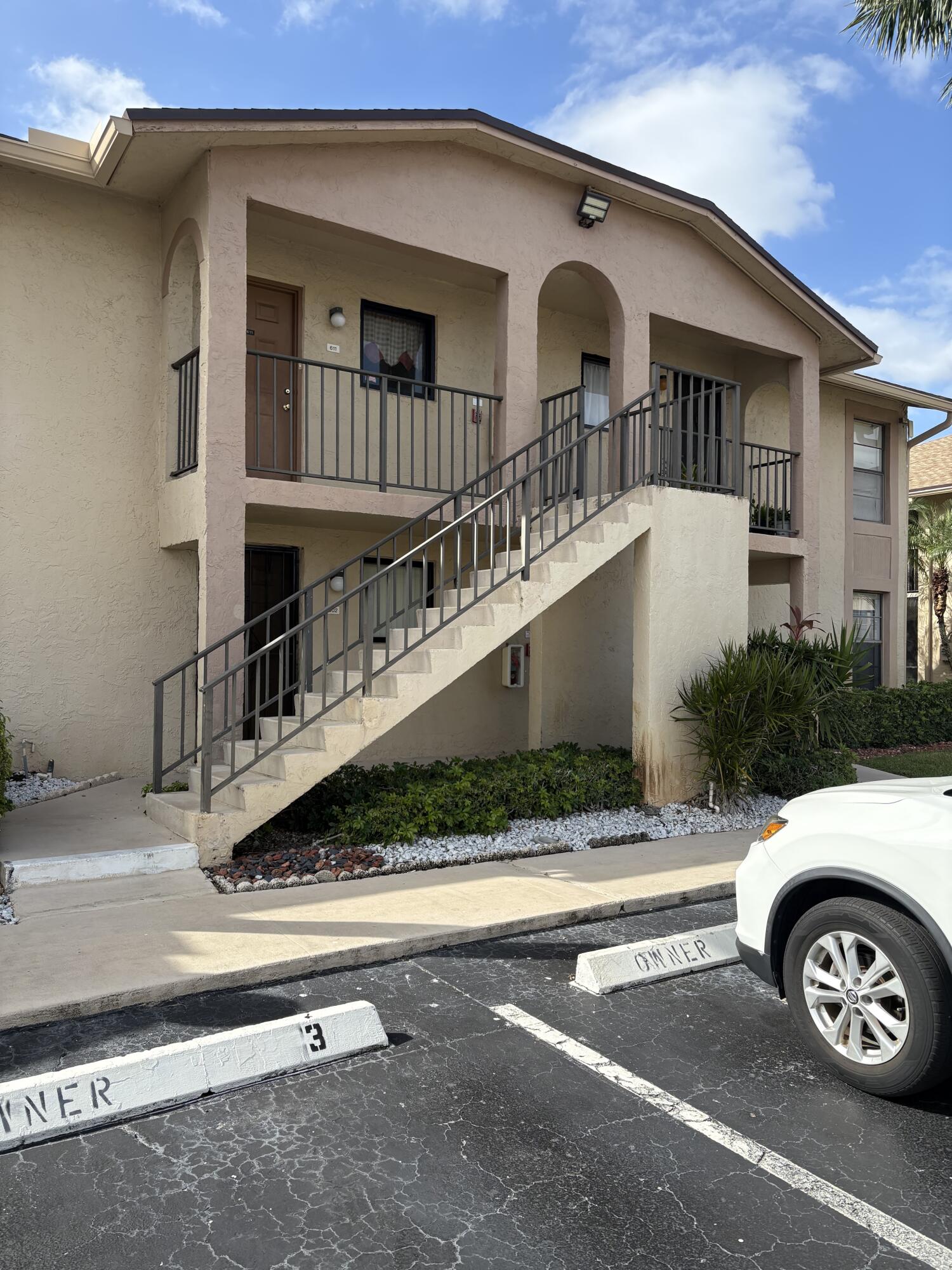 9503 Boca Cove Circle, Unit 602 Boca Raton, FL 33428 - Photo 6 of 24 a front view of a house with parking