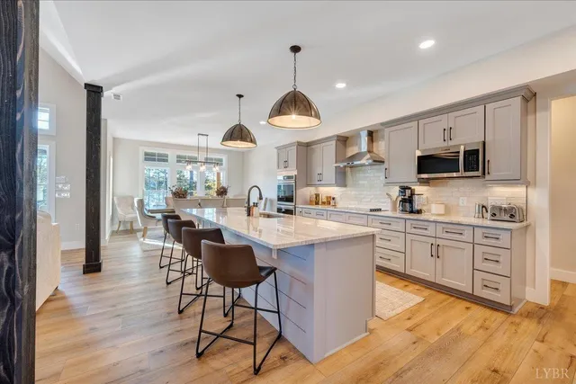 a dining room with furniture a chandelier and wooden floor