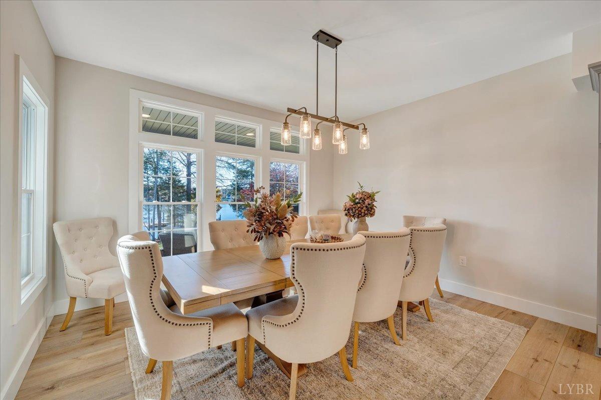 317 Bass Cove Road Huddleston, VA 24104 - Photo 19 of 90 a dining room with furniture a chandelier and wooden floor
