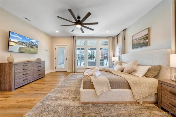 a spacious bedroom with a bed and a large window