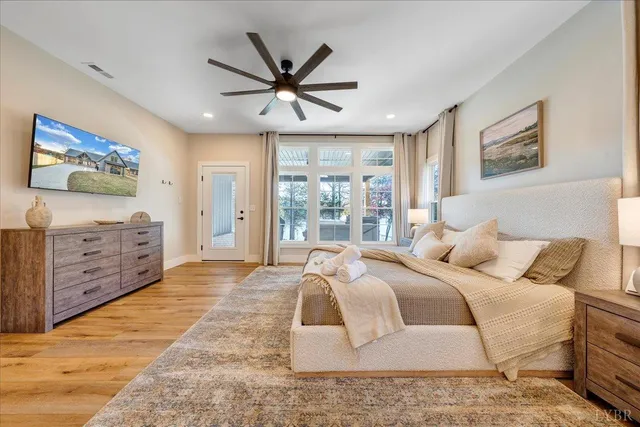 a spacious bedroom with a bed and a large window