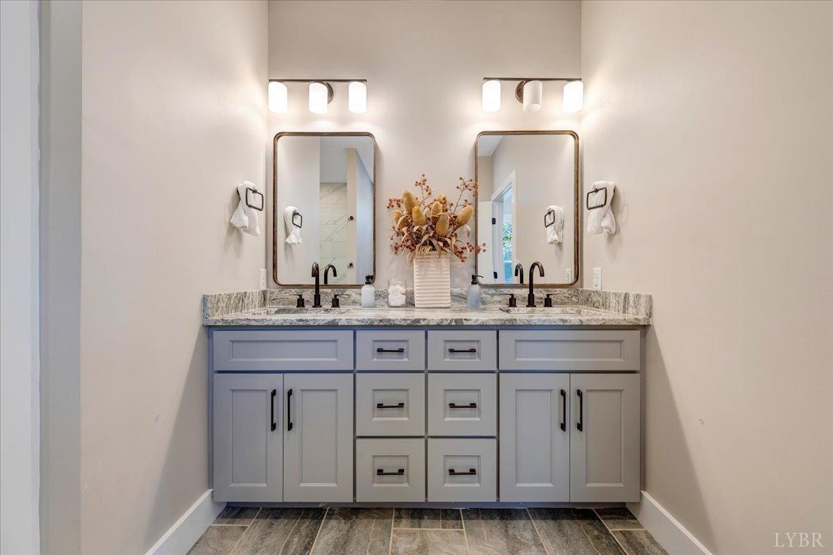 317 Bass Cove Road Huddleston, VA 24104 - Photo 24 of 90 a bathroom with a double vanity sink and a mirror