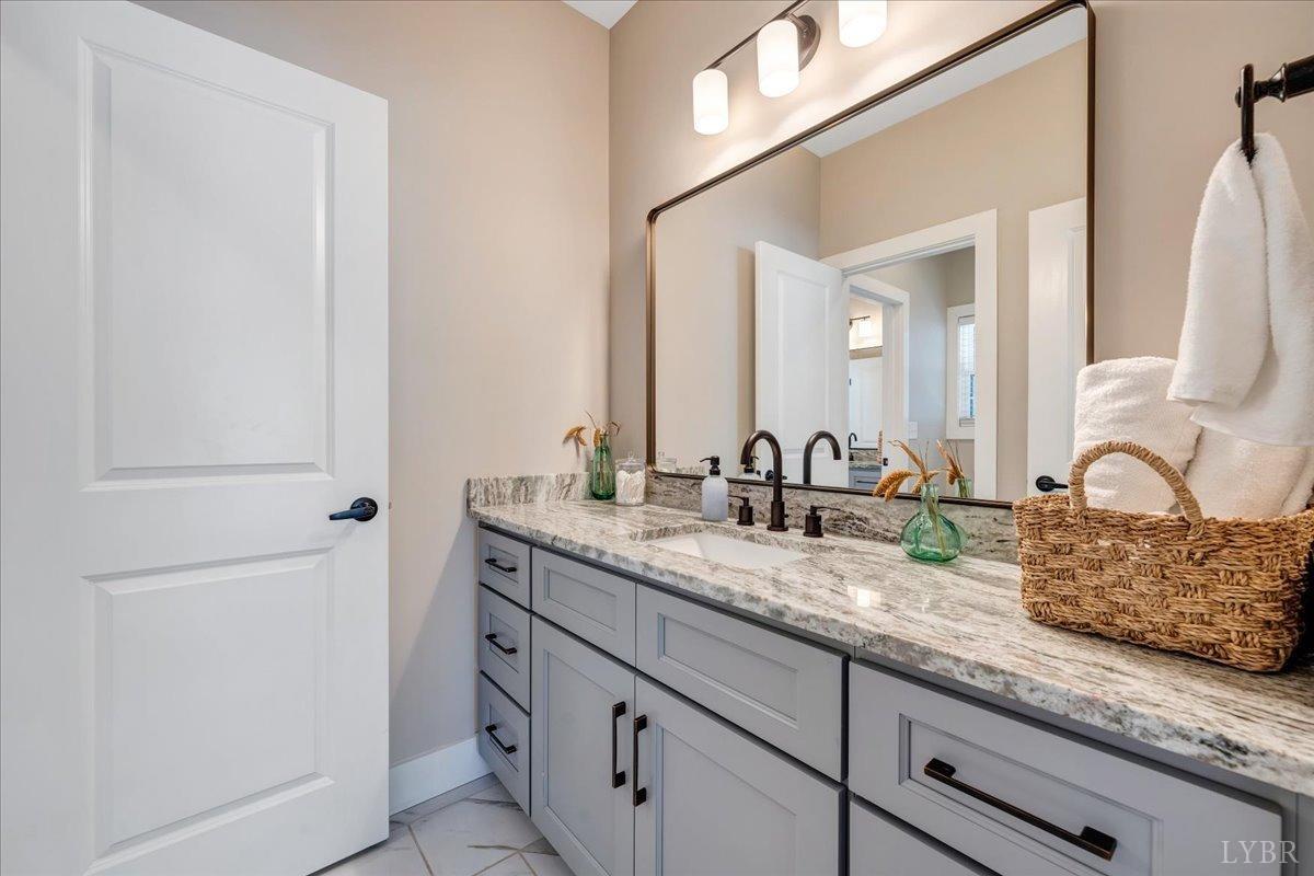 317 Bass Cove Road Huddleston, VA 24104 - Photo 34 of 90 a bathroom with a granite countertop sink and a mirror