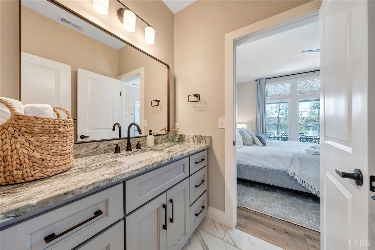 317 Bass Cove Road Huddleston, VA 24104 - Photo 35 of 90 a en suite bathroom with a granite countertop tub and 2 sink