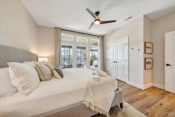 a dining room with furniture and a floor to ceiling window