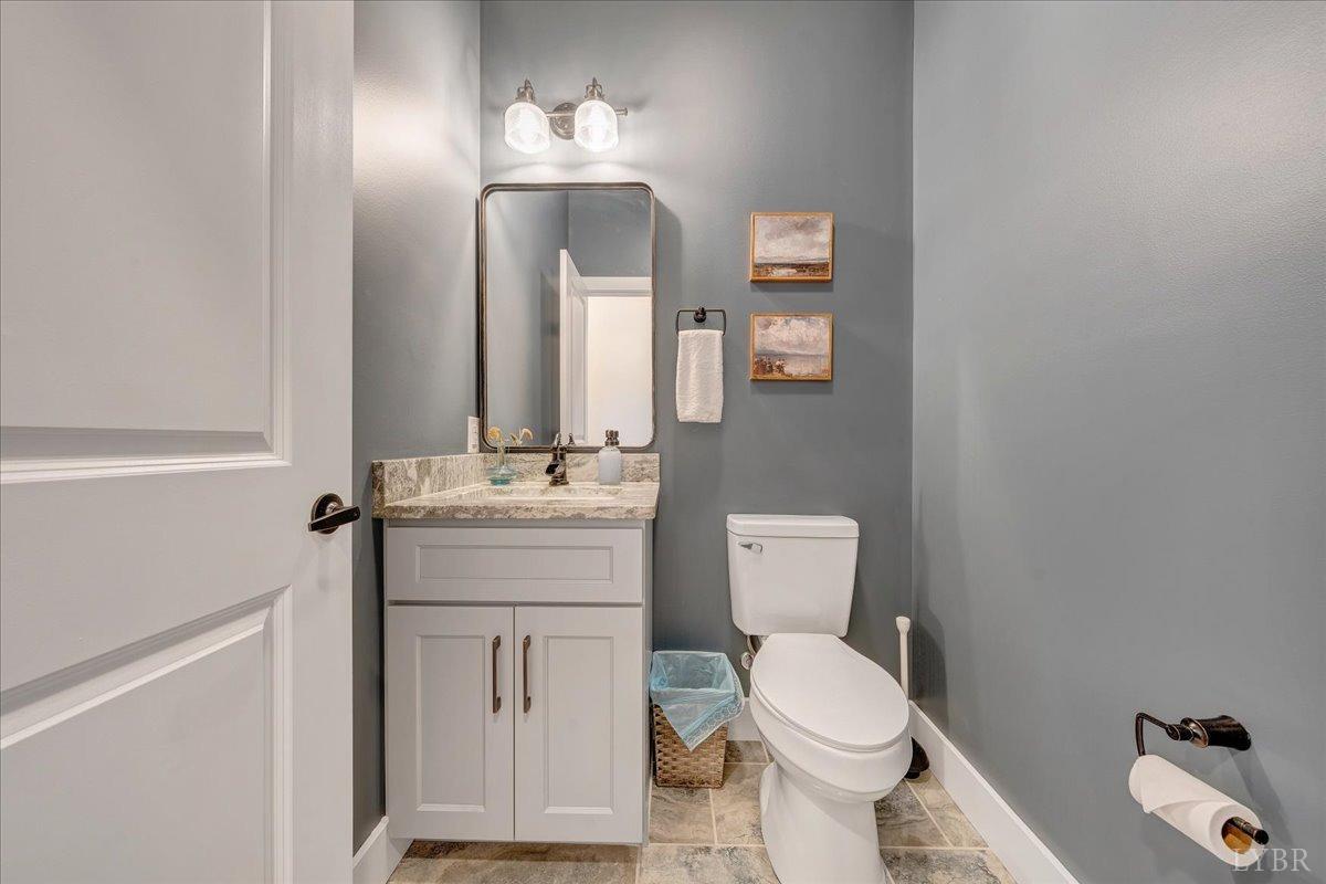 317 Bass Cove Road Huddleston, VA 24104 - Photo 39 of 90 a bathroom with a toilet a sink and mirror
