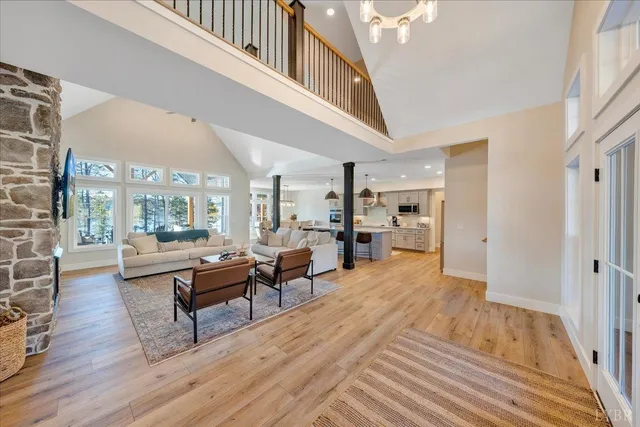 a kitchen with stainless steel appliances a stove a sink and chairs