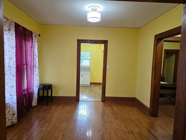 a view of a room with wooden floor and closet