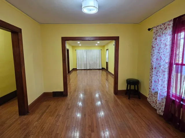 a view of a room with wooden floor and furniture