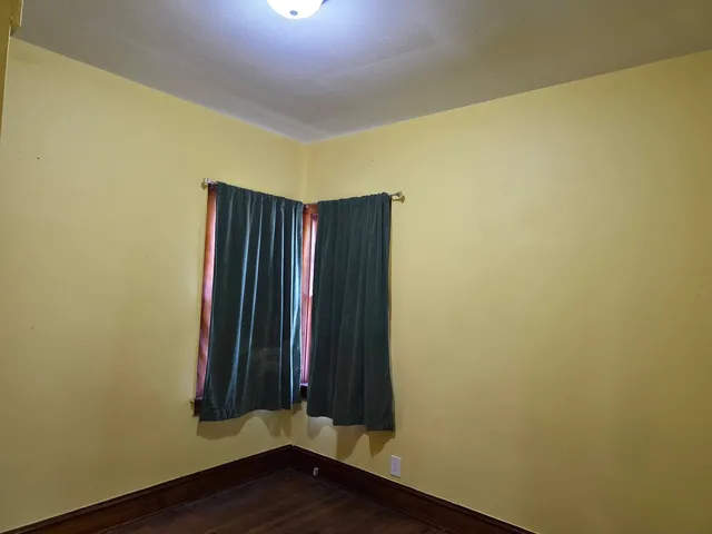 an empty room with wooden floor