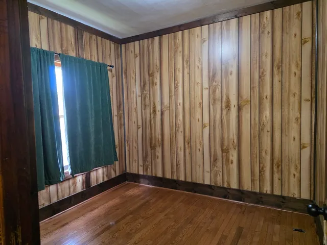 a view of a room with wooden floor and windows