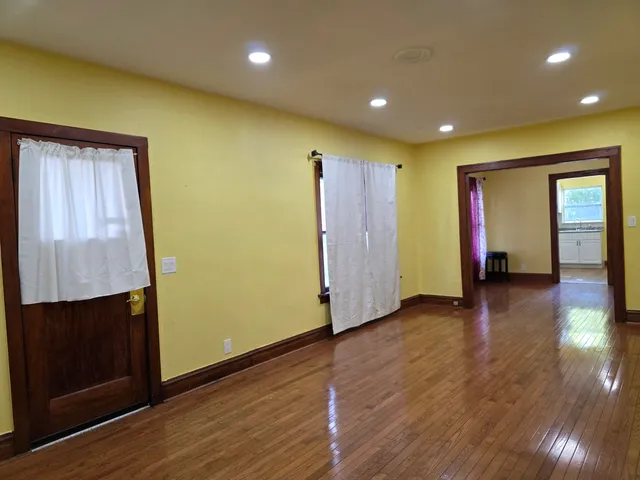 an empty room with wooden floor and closet