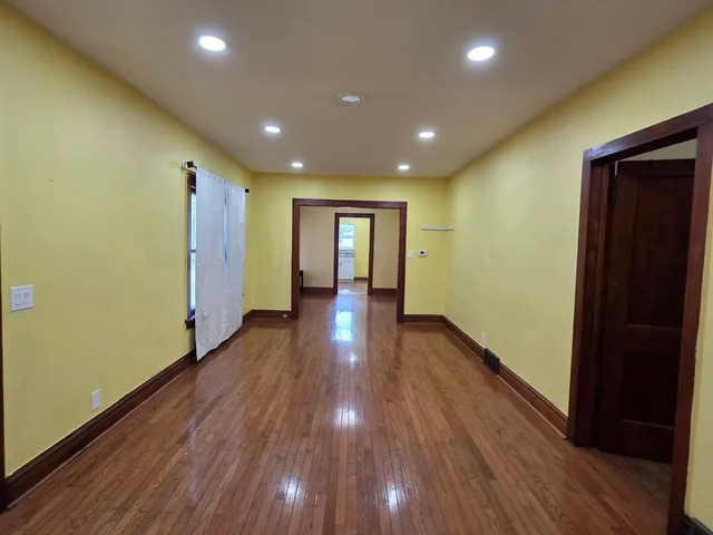a view of hallway with wooden floor