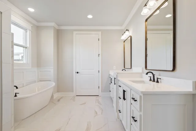 an empty room with windows and ceiling fan