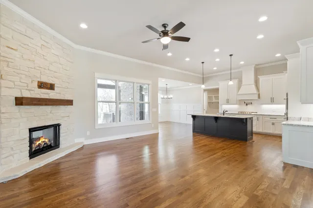 a kitchen with stainless steel appliances granite countertop a sink stove and cabinets