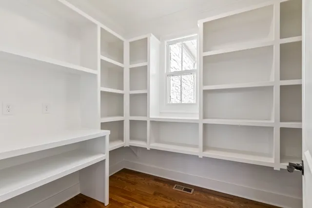 a view of an empty room and wooden floor