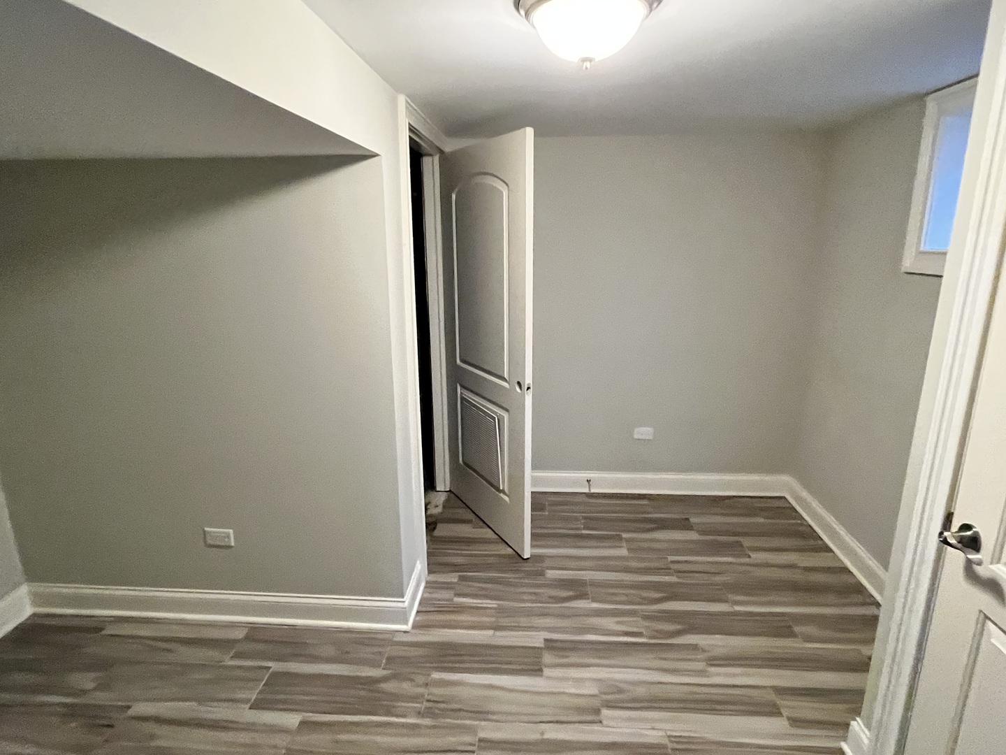 1253 Sunset Ridge Road Northbrook, IL 60062 - Photo 26 of 31 an empty room with wooden floor and entrance