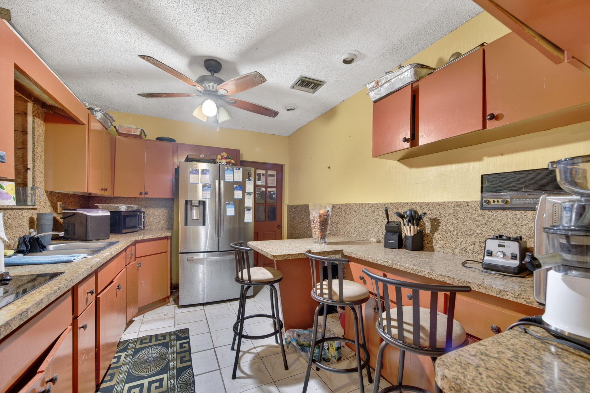 9281 Martinique Drive Miami, FL 33189 - Photo 16 of 35 a kitchen with stainless steel appliances kitchen island granite countertop a sink and cabinets