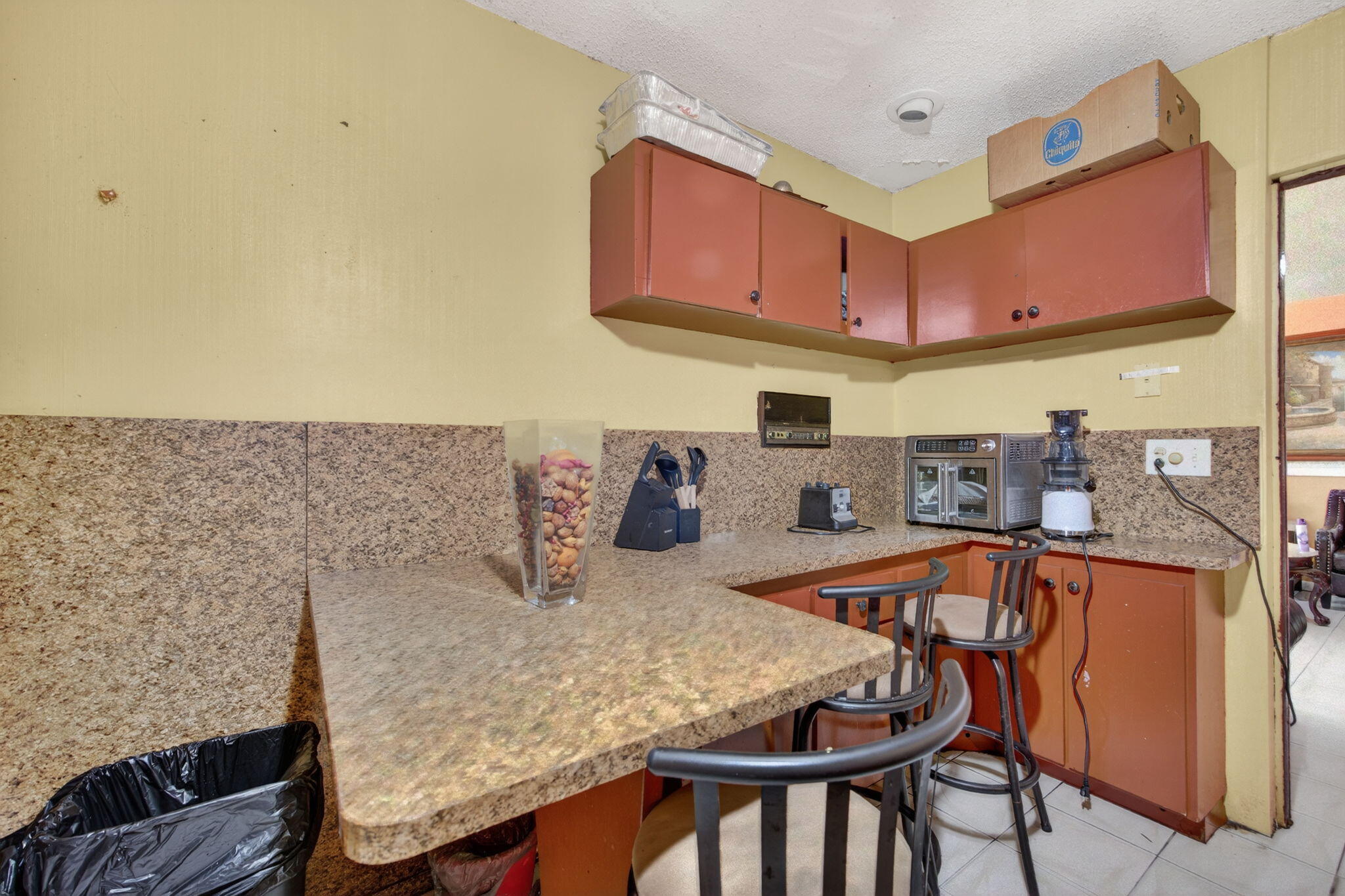 9281 Martinique Drive Miami, FL 33189 - Photo 17 of 35 a kitchen with stainless steel appliances granite countertop a table chairs in it and wooden floor