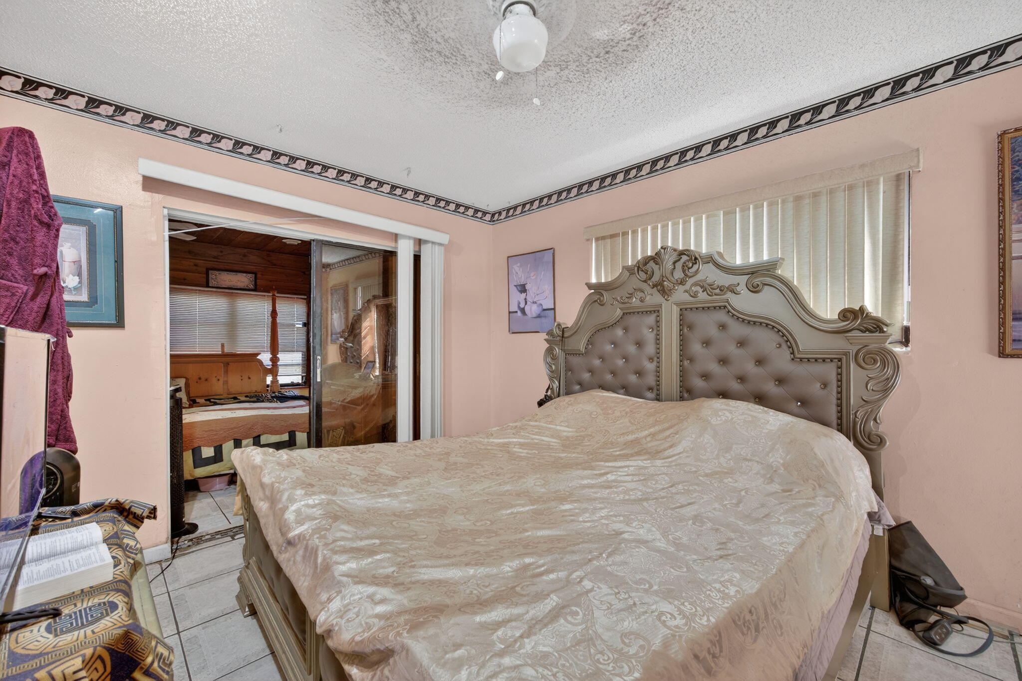 9281 Martinique Drive Miami, FL 33189 - Photo 20 of 35 a large bed sitting in a bedroom next to a window