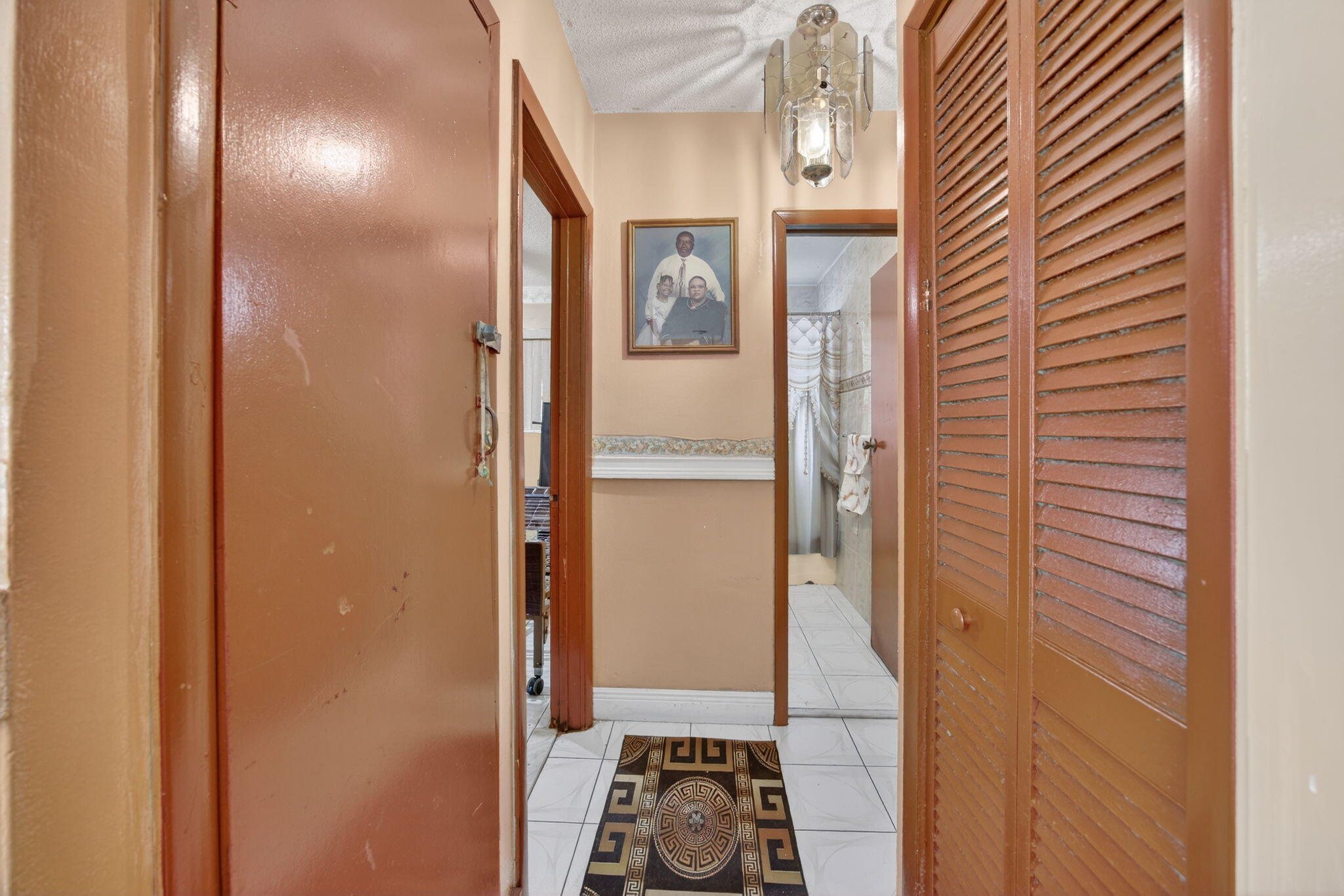9281 Martinique Drive Miami, FL 33189 - Photo 30 of 35 a view of a hallway with wooden floor and a bathroom