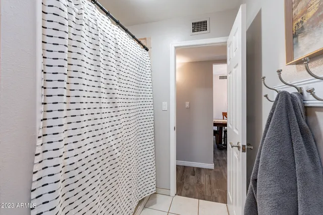 a bedroom with a bed and a large mirror