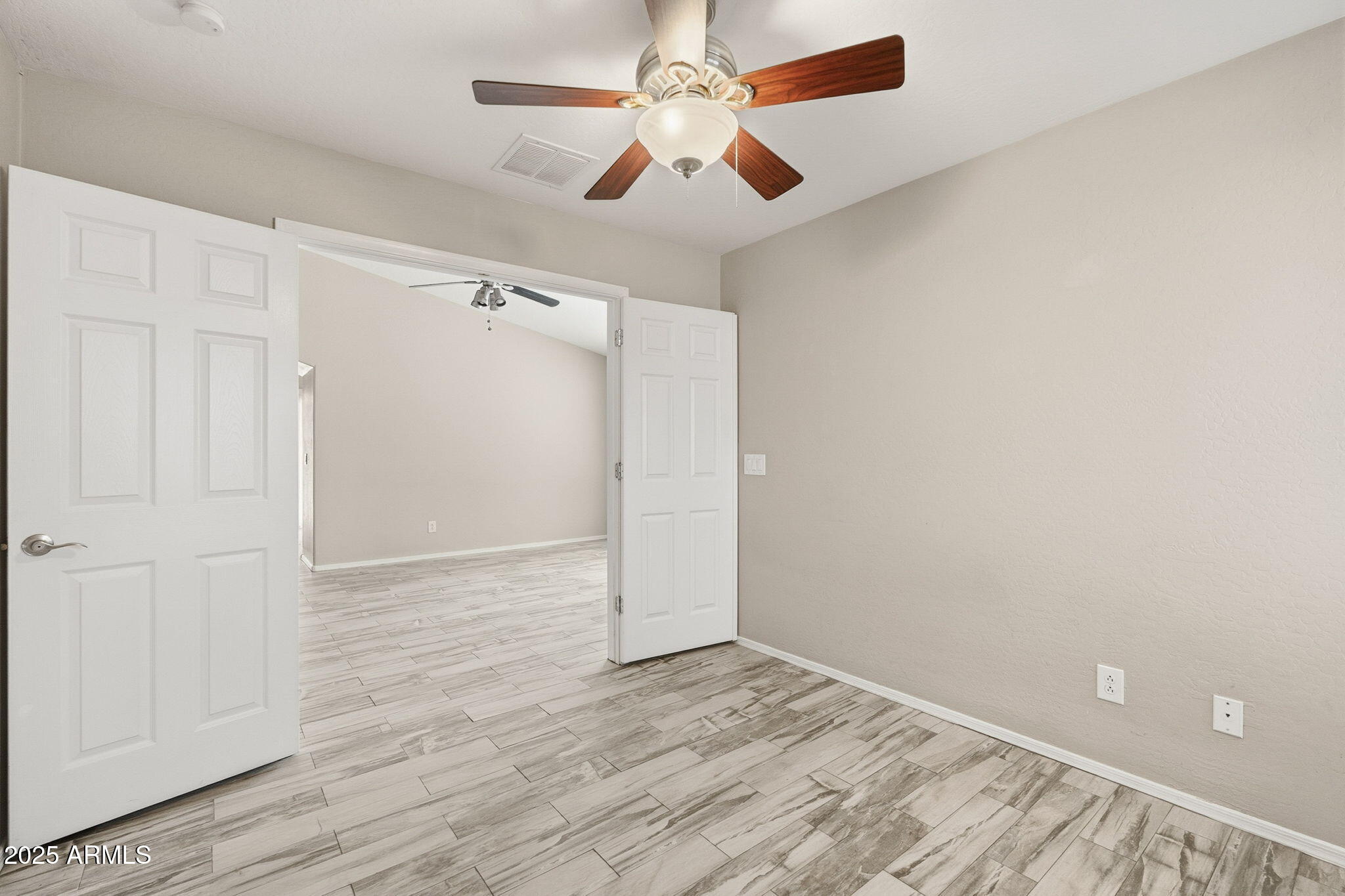 227 South 16th Street Coolidge, AZ 85128 - Photo 10 of 34 an empty room with wooden floor fan and windows