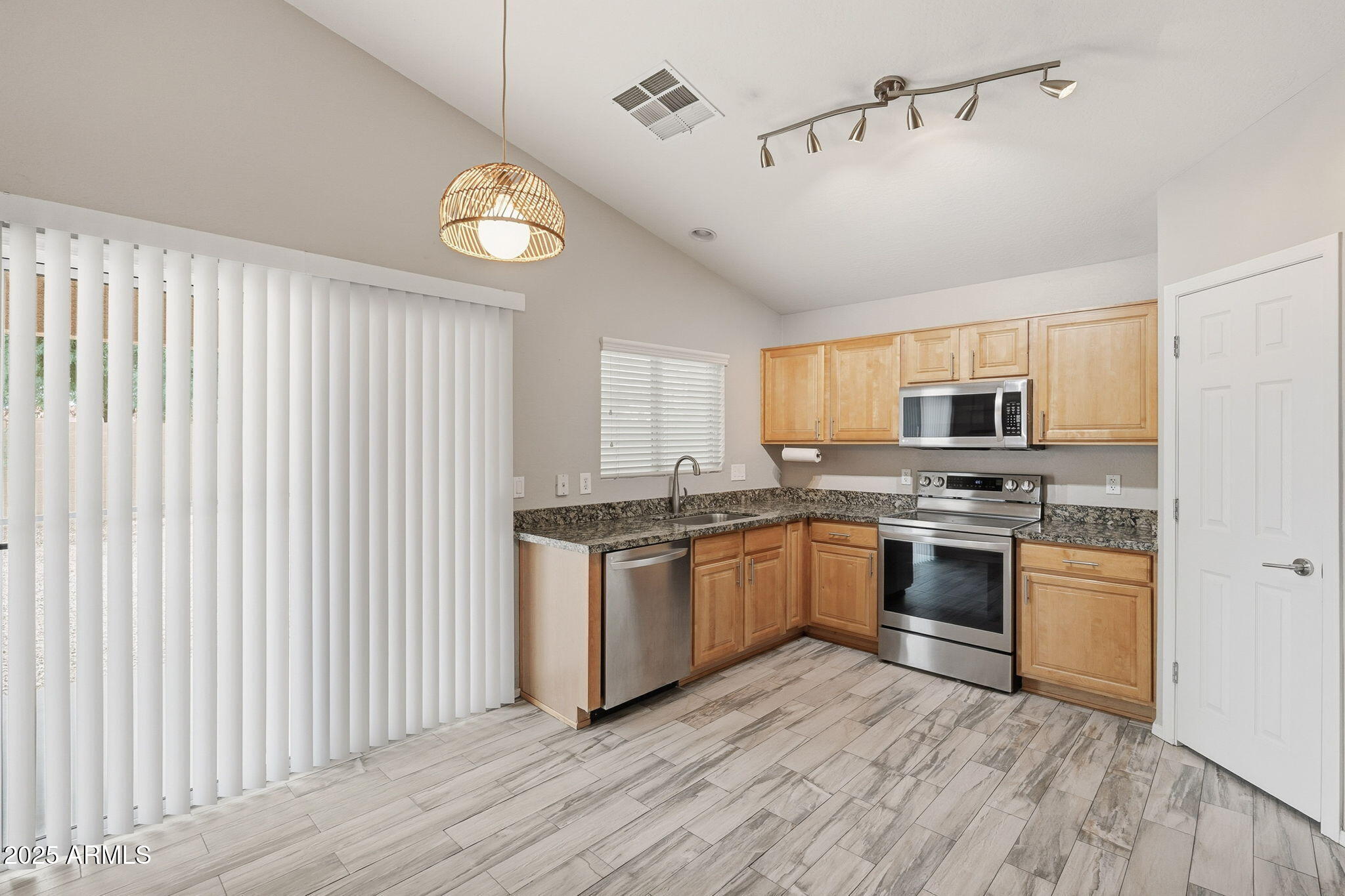 227 South 16th Street Coolidge, AZ 85128 - Photo 11 of 34 a kitchen with stainless steel appliances granite countertop a stove and a sink