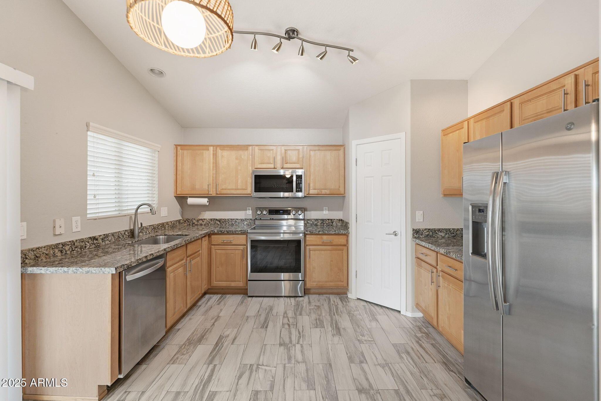 227 South 16th Street Coolidge, AZ 85128 - Photo 12 of 34 a kitchen with kitchen island granite countertop a sink appliances cabinets and counter space