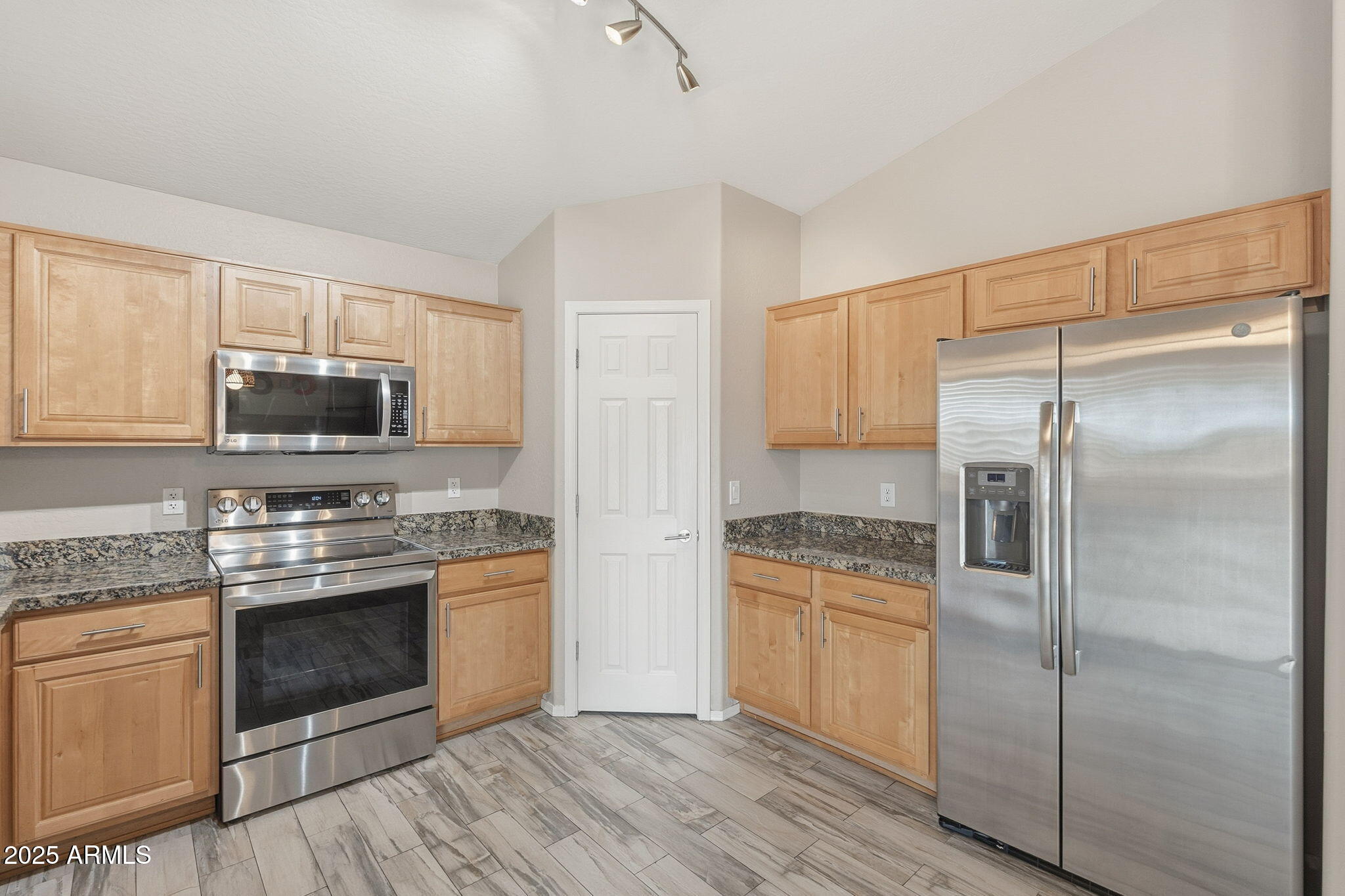 227 South 16th Street Coolidge, AZ 85128 - Photo 13 of 34 a kitchen with a stove refrigerator and microwave