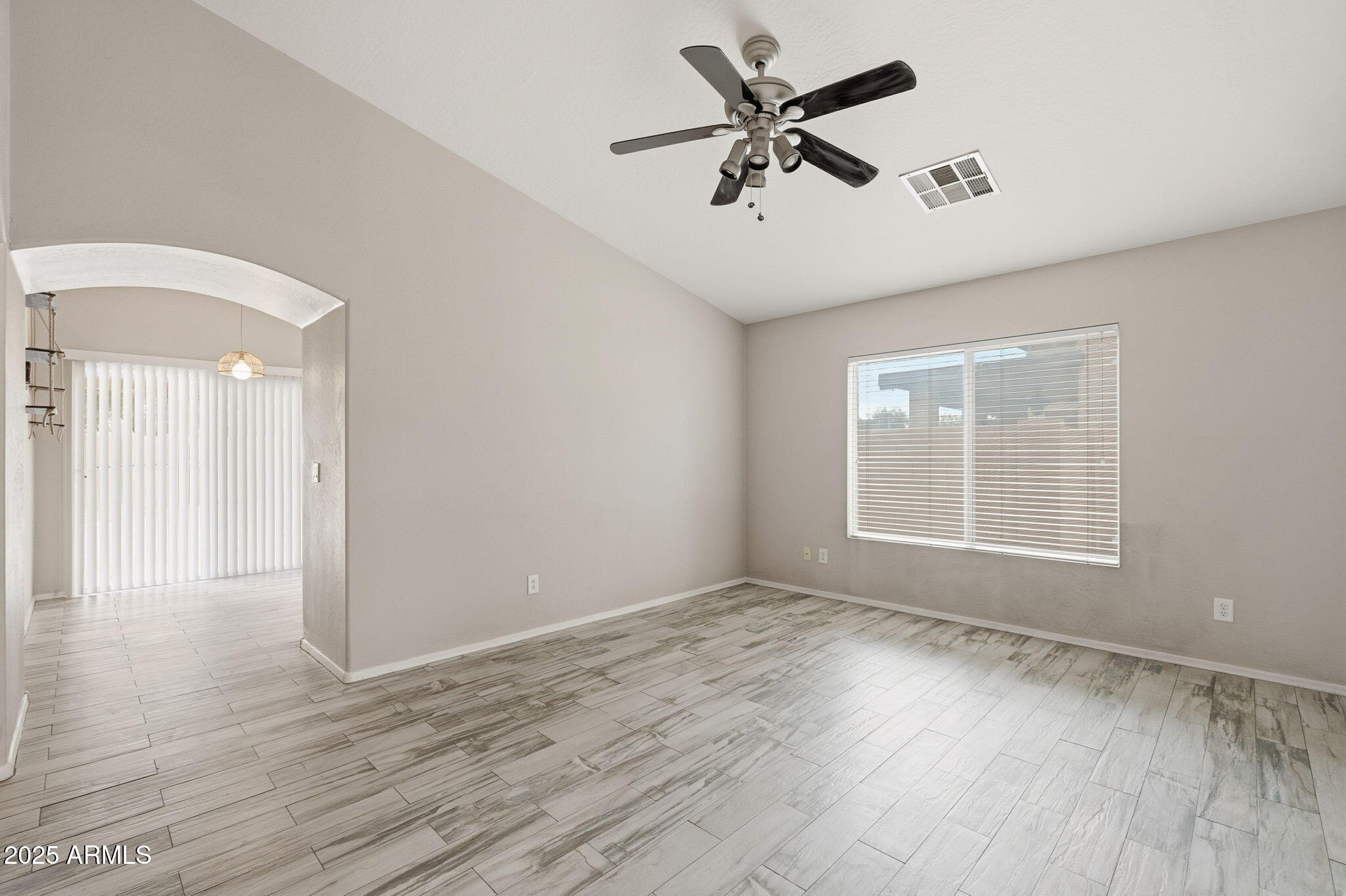227 South 16th Street Coolidge, AZ 85128 - Photo 7 of 34 an empty room with wooden floor and windows