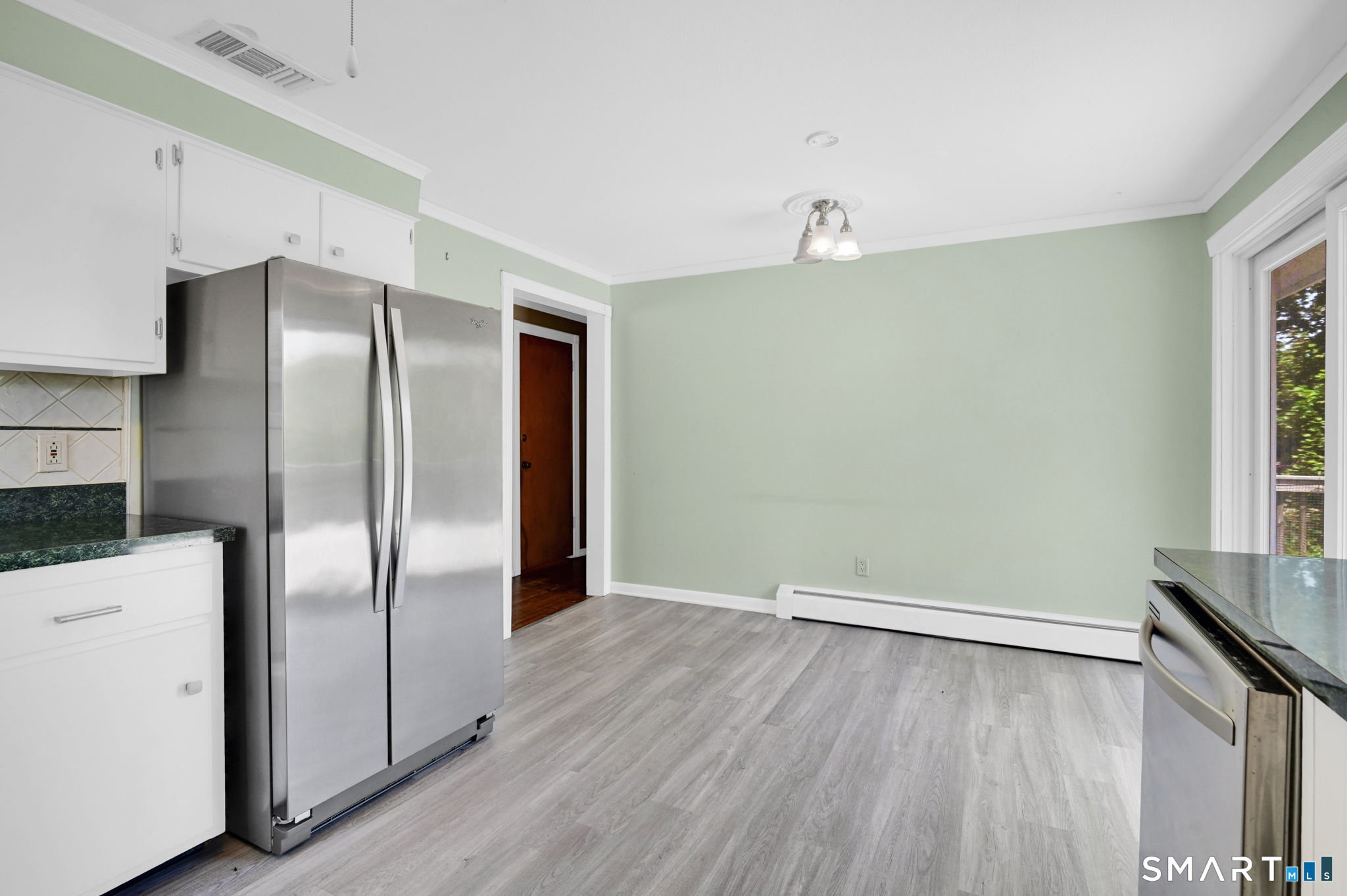7 Rogers Drive Meriden, CT 06450 - Photo 15 of 40 a view of a refrigerator in kitchen and wooden floor