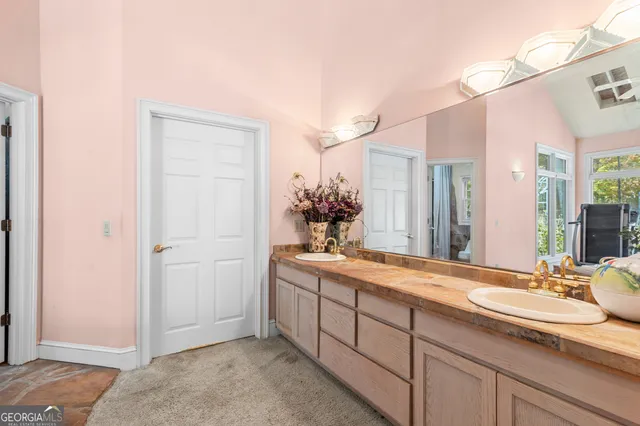 a view of walk in closet with clothes