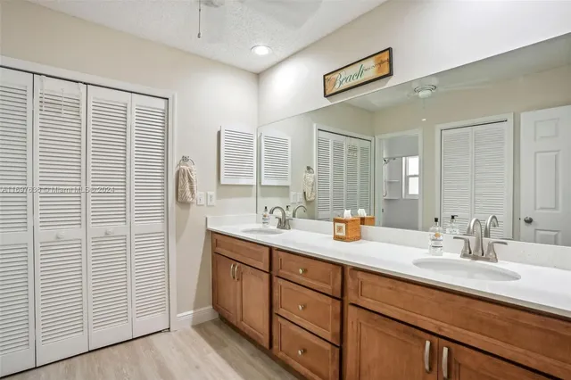 a bathroom with double sink and a mirror