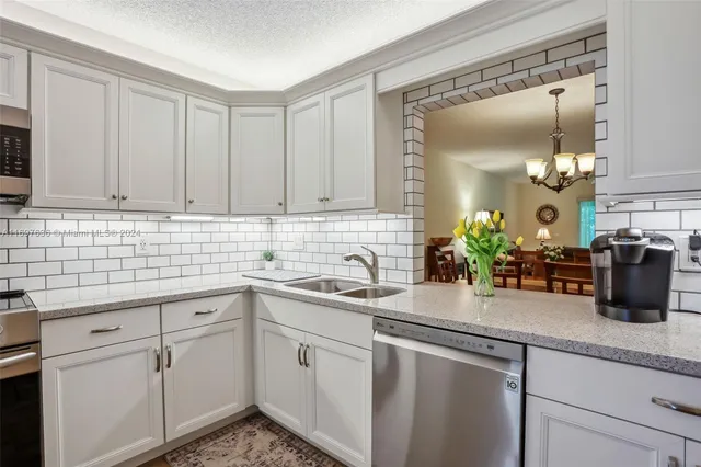a kitchen with sink and cabinets