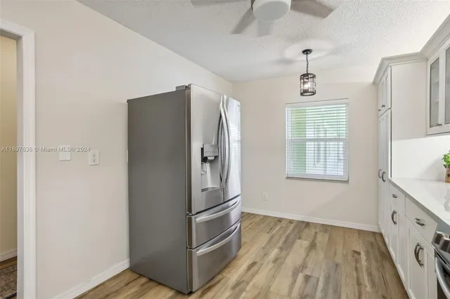 a kitchen with stainless steel appliances a refrigerator and a window