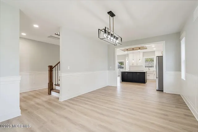 a view of a kitchen with a sink and dishwasher wooden floor