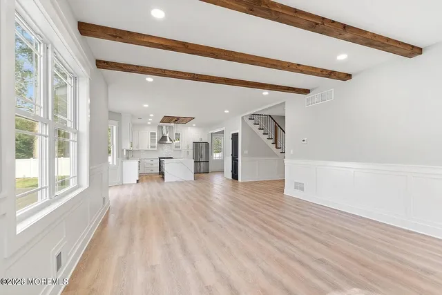 a view of an entryway with wooden floor and windows