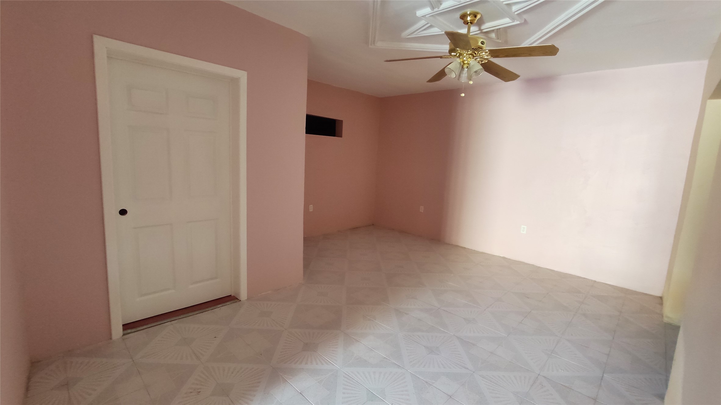 146 Calle Cuahtemoc Avenue Columbus, IN 47203 - Photo 12 of 26 an empty room with a ceiling fan and a window