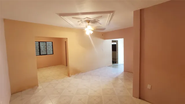 a view of a big room with closet and a chandelier fan