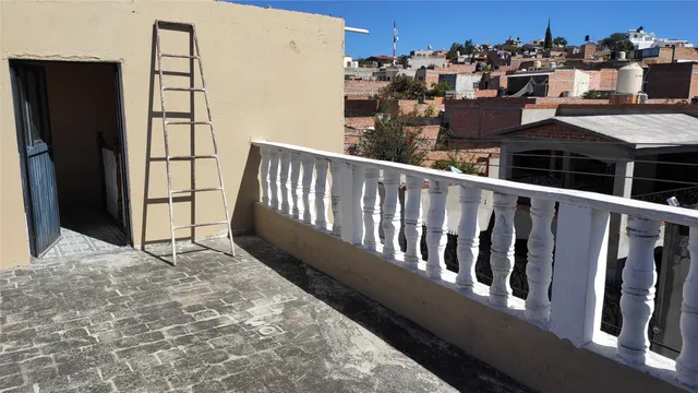 a view of a balcony with wooden fence