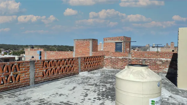 a front view of a house with wooden fence