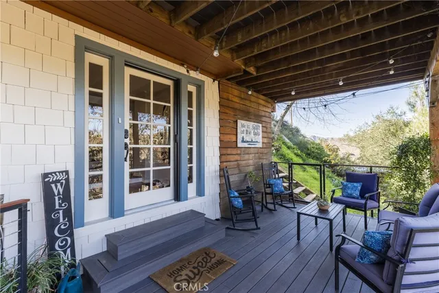 a view of a chairs and table in patio with wooden floor