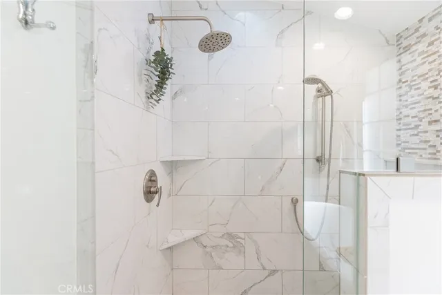 a bedroom with a bed and a flat tv screen in it