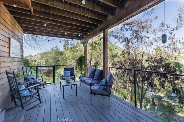 a view of a bedroom with wooden floor and windows