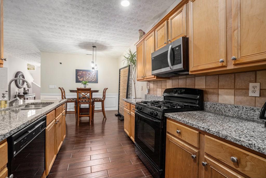 771 Nehemiah Lane Atlanta, GA 30331 - Photo 13 of 30 a kitchen with stainless steel appliances granite countertop a stove a sink and a microwave